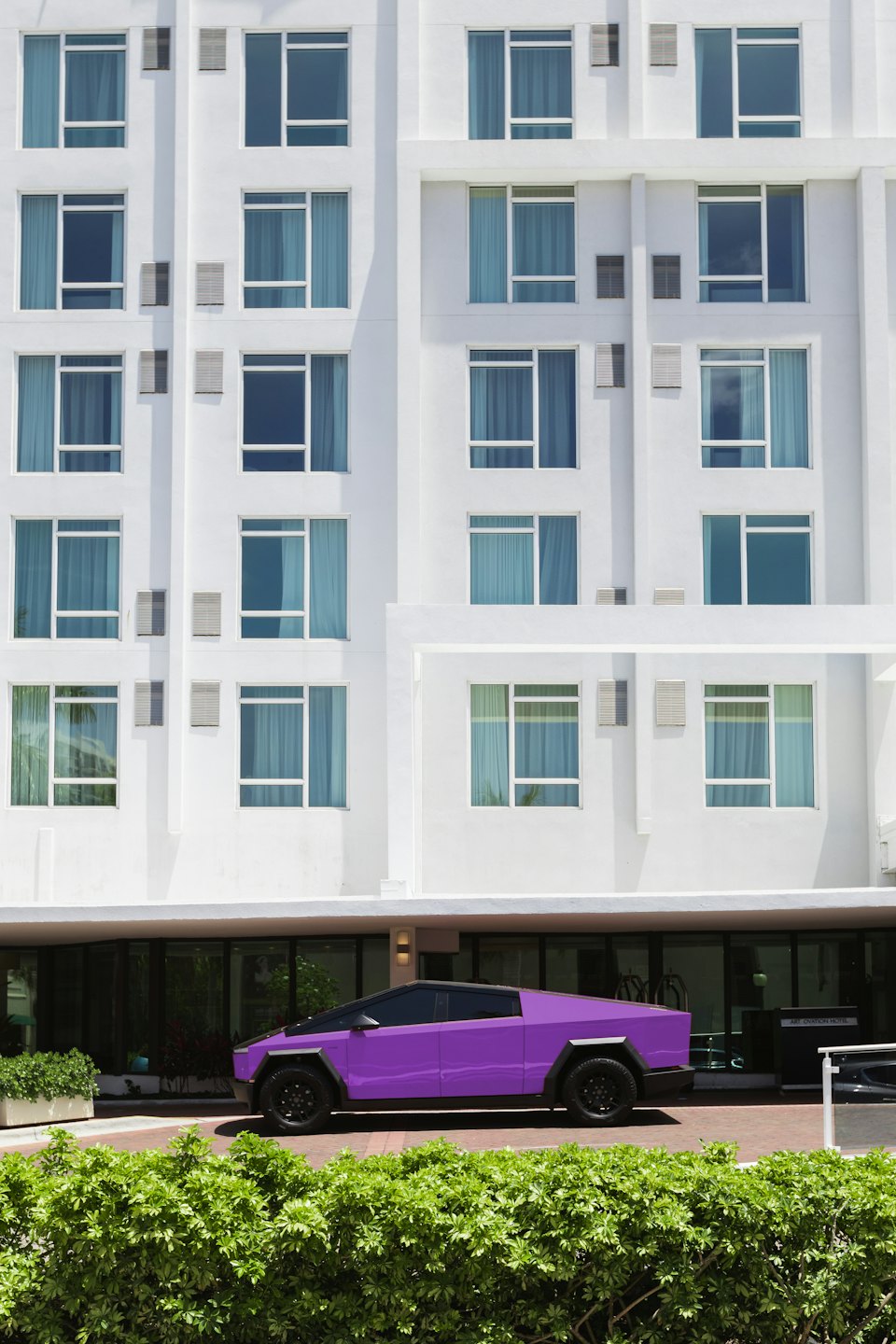 Purple futuristic electric truck parked before a modern white building.